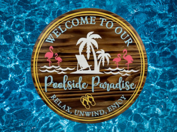 round wood pool sign in summer colors that says welcome to our poolside paradise