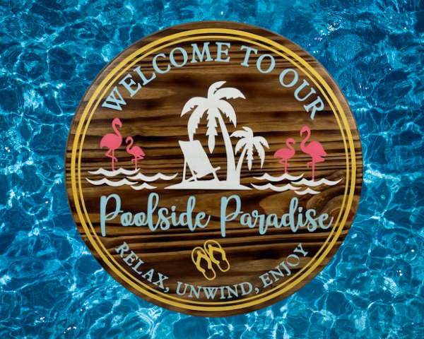 round wood pool sign in summer colors that says welcome to our poolside paradise