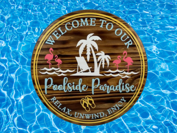 round wood pool sign in summer colors that says welcome to our poolside paradise