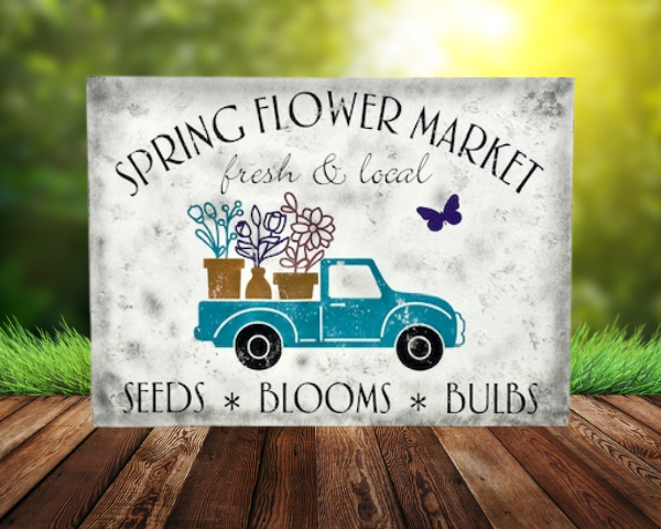 white distressed sawdust textured spring sign with teal truck carrying flowers