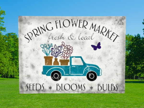 white distressed sawdust textured spring sign with teal truck carrying flowers