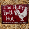 rustic sign with a red sawdust-textured background, featuring a chicken illustration and the text 'Fluffy Butt Hut - Welcome Mother Cluckers'