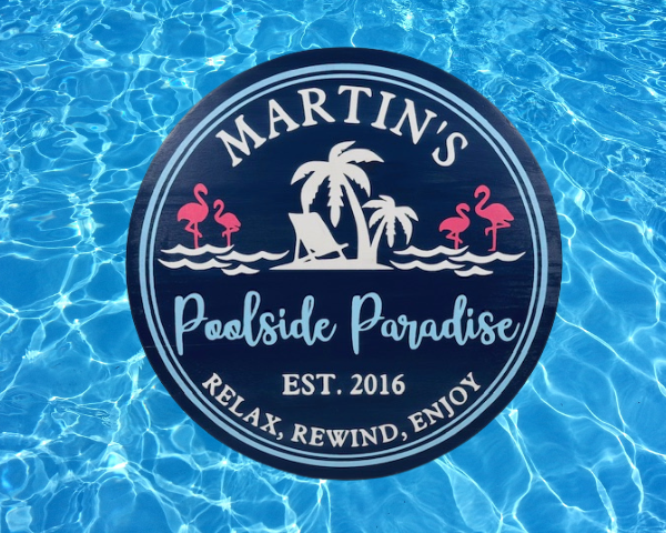 customizable deep blue round wood pool sign that reads 'Poolside Paradise - Relax, Rewind, Enjoy