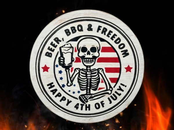 distressed round wood sign that reads Happy 4th of July and includes the phrase Beer, BBQ, and Freedom; sign features a skeleton in the center, smiling and holding a cold mug of beer