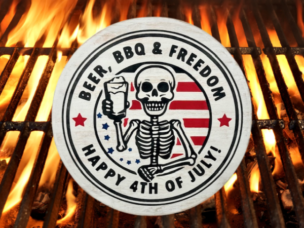 distressed round wood sign that reads Happy 4th of July and includes the phrase Beer, BBQ, and Freedom; sign features a skeleton in the center, smiling and holding a cold mug of beer