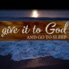an Early American stained rustic sign made of cedar fence pickets that reads Give it to God and Go to Sleep