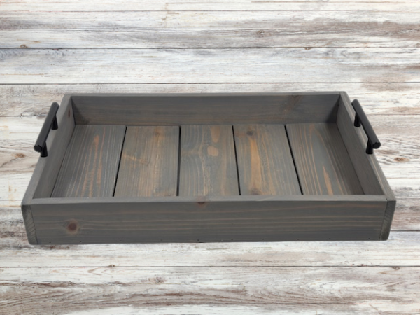 rustic gray serving tray that has been torched and then stained in weathered gray; black handles on both sides finish off this charming tray