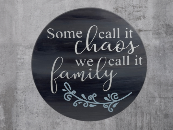 charming and elegant wood round sign that reads some call it chaos we call it family; colors are barnwood stain with ivory and light blue lettering