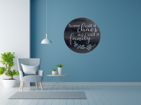 charming and elegant wood round sign that reads some call it chaos we call it family; colors are barnwood stain with ivory and light blue lettering