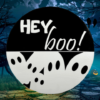 black and white pine round Halloween sign that has ghosts at the bottom and reads Hey Boo! on the top