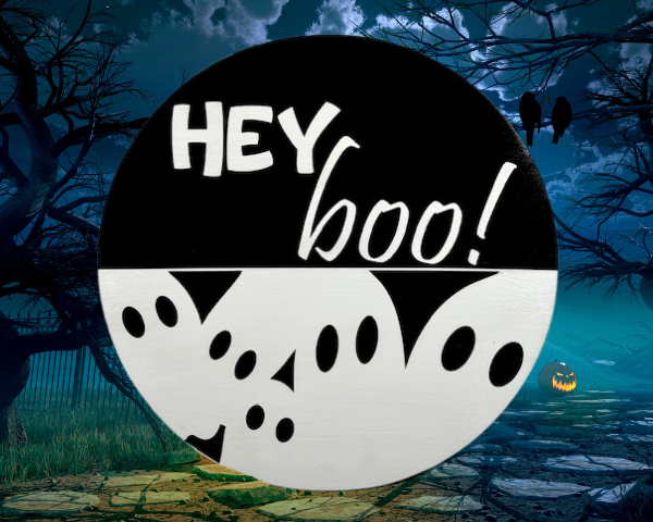 black and white pine round Halloween sign that has ghosts at the bottom and reads Hey Boo! on the top