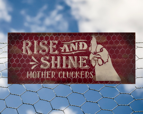 distressed and rustic red background sign with silver chicken wire - signs reads Rise and Shine Mother Cluckers