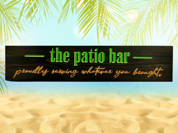 colorful lime green, orange, and yellow sign that reads "the patio bar - proudly serving whatever you brought"