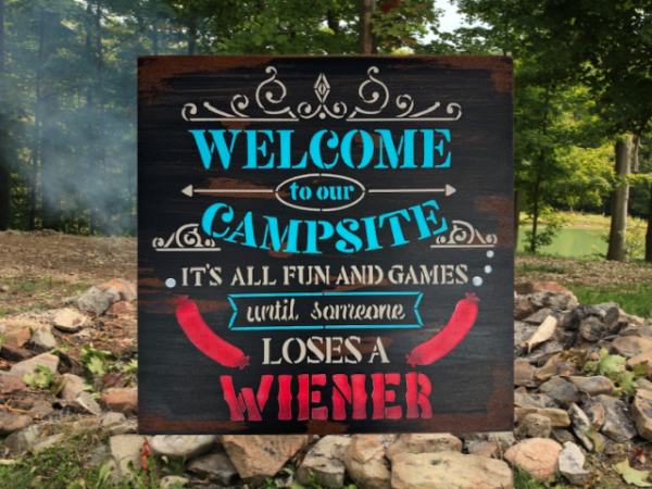 rustic camping sign that reads "Welcome to our campsite, it's all fun and games until someone loses a wiener