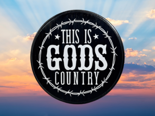 beautiful black and white pine wood round sign that reads "This is Gods Country" with painted barbed wire around the sign