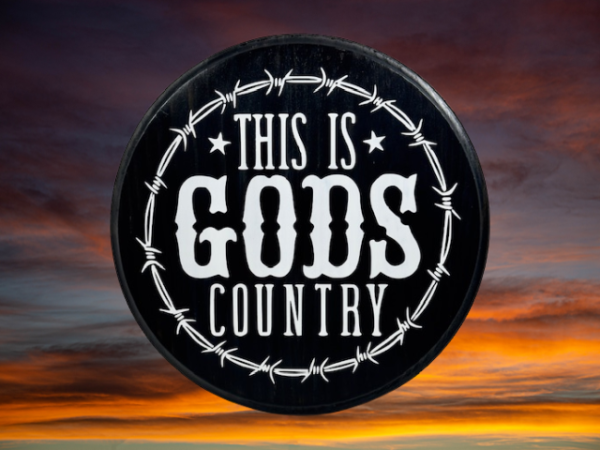 beautiful black and white pine wood round sign that reads "This is Gods Country" with painted barbed wire around the sign