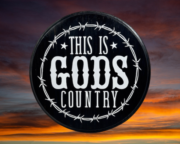 beautiful black and white pine wood round sign that reads "This is Gods Country" with painted barbed wire around the sign