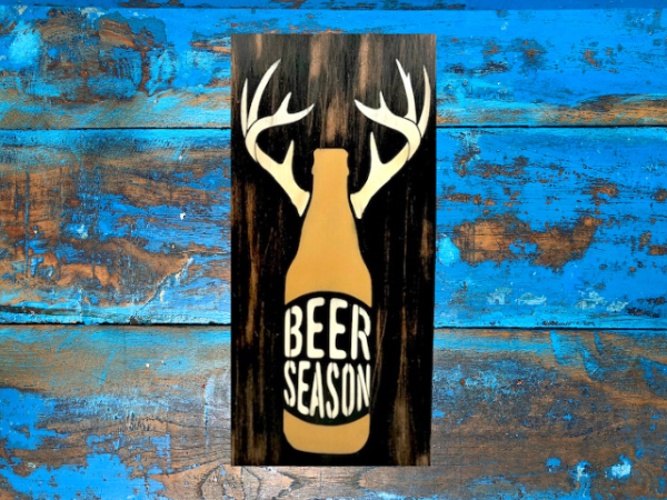 rustic and distressed hunting sign that has a beer bottle with antlers and reads "Beer Season"