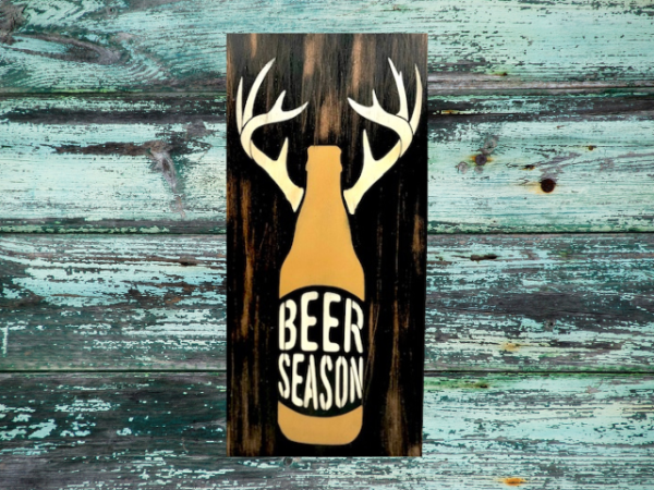 rustic and distressed hunting sign that has a beer bottle with antlers and reads "Beer Season"