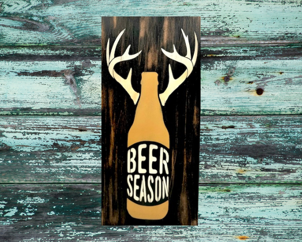 rustic and distressed hunting sign that has a beer bottle with antlers and reads "Beer Season"