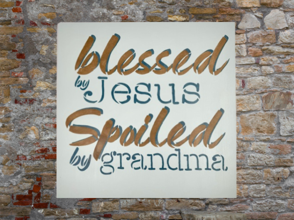 sign that reads "Blessed by Jesus Spoiled by Grandma" on a calm, pastel blue background