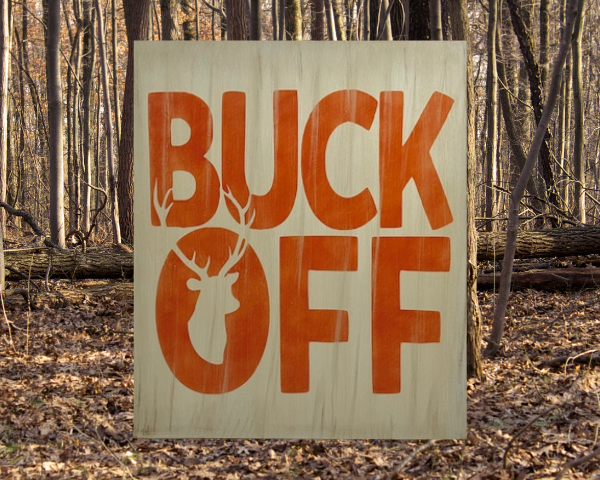 rustic tan hunting sign with orange letters that says "Buck Off