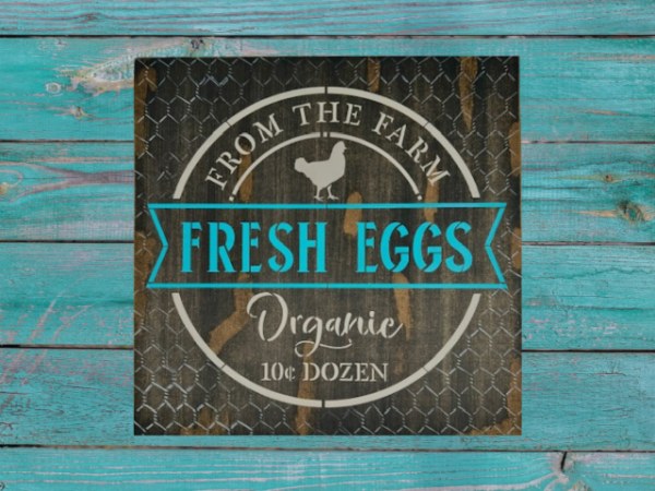 brown rustic and distressed sign with vibrant teal and tan lettering - sign says Fresh Eggs from the Farm