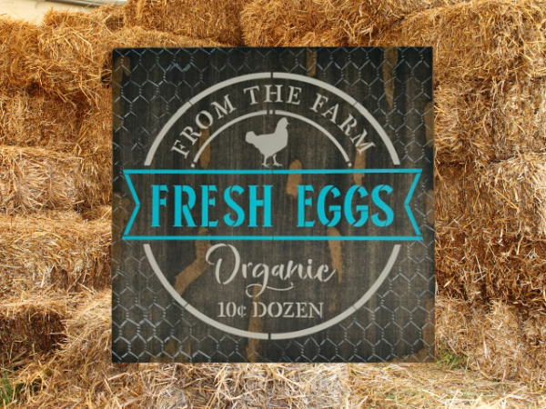 brown rustic and distressed sign with vibrant teal and tan lettering - sign says Fresh Eggs from the Farm