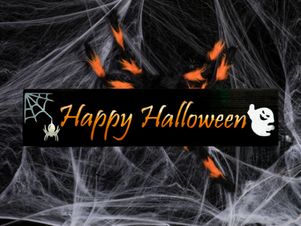 spooky halloween sign made of a fence picket - sign has a black background with a spider web in one corner and a ghost in the other corner - Happy Halloween is written in the center in yellow, orange, and white ombre