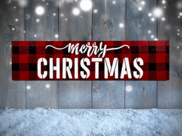 festive Christmas sign with black and red plaid background and the worlds "Merry Christmas" centered in bold white cursive lettering