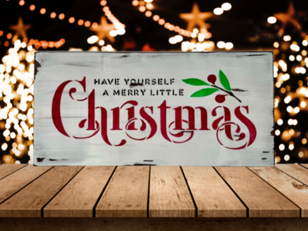 distressed white Christmas sign that reads "Have Yourself a Merry Little Christmas" in festive lettering