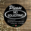 Please No Soliciting pine wood round sign that says Please No Soliciting - It's not personal, we just dont want to talk to you, or hear you, or see you. Black background and crisp white lettering finish off this cheerful sign