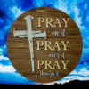 laser-etched inspirational pine wood round sign that reads Pray on it, Pray over it, Pray through it - Early American stain with Buff and Copen blue lettering