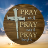 laser-etched inspirational pine wood round sign that reads Pray on it, Pray over it, Pray through it - Early American stain with Buff and Copen blue lettering