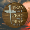 laser-etched inspirational pine wood round sign that reads Pray on it, Pray over it, Pray through it - Early American stain with Buff and Copen blue lettering