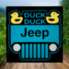 sign with a black background and teal jeep that has two bright yellow ducks in the corners