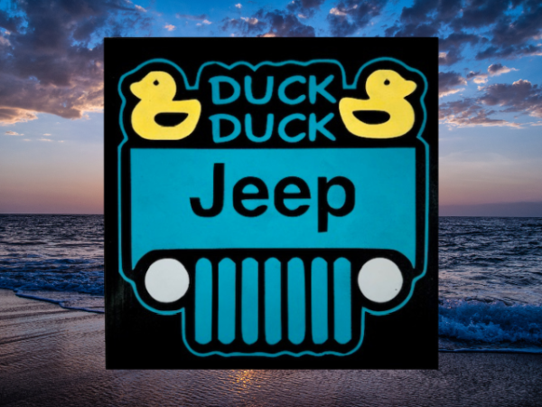 sign with a black background and teal jeep that has two bright yellow ducks in the corners