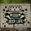 Rugged and muddy Jeep sign - Jeep is black with mud all over the windshield and roadway, sign says Jeep Life