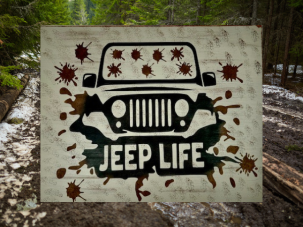 Rugged and muddy Jeep sign - Jeep is black with mud all over the windshield and roadway, sign says Jeep Life