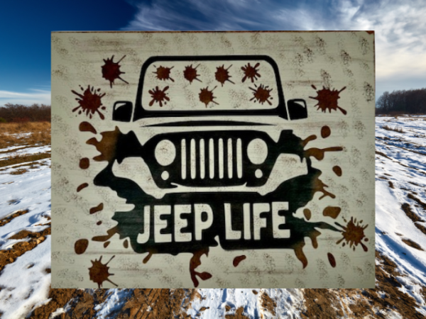 Rugged and muddy Jeep sign - Jeep is black with mud all over the windshield and roadway, sign says Jeep Life