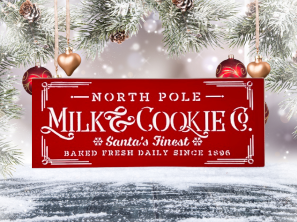 festive holiday sign with a Christmas red background and crisp white lettering that says "North Pole Milk & Cookies Co"