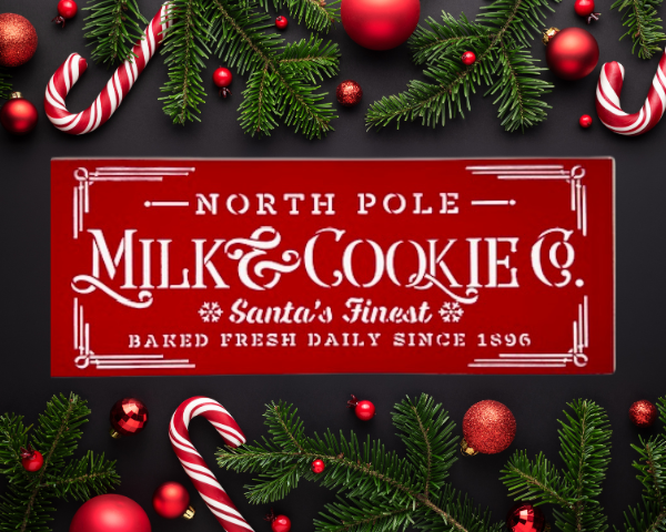 festive holiday sign with a Christmas red background and crisp white lettering that says "North Pole Milk & Cookies Co"