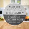 beautiful round lazy susan in two-toned Weathered Gray stain and Silver Lining paint - protected in epoxy coating - reads "Bless the food before us, the family beside us and the love between us"
