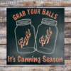 funny kitchen sign that says "Grab Your Balls It's Canning Season" with 2 iconic Ball Jars in the middle of the sign