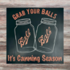 funny kitchen sign that says "Grab Your Balls It's Canning Season" with 2 iconic Ball Jars in the middle of the sign