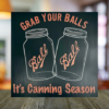 funny kitchen sign that says "Grab Your Balls It's Canning Season" with 2 iconic Ball Jars in the middle of the sign