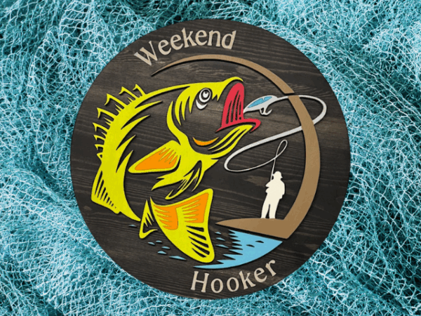 a rustic pine wood sign with a black stain finish, featuring laser-cut "Weekend Hooker" text, a vibrant lime green fish, and a fisherman silhouette, blending bold humor and fishing charm