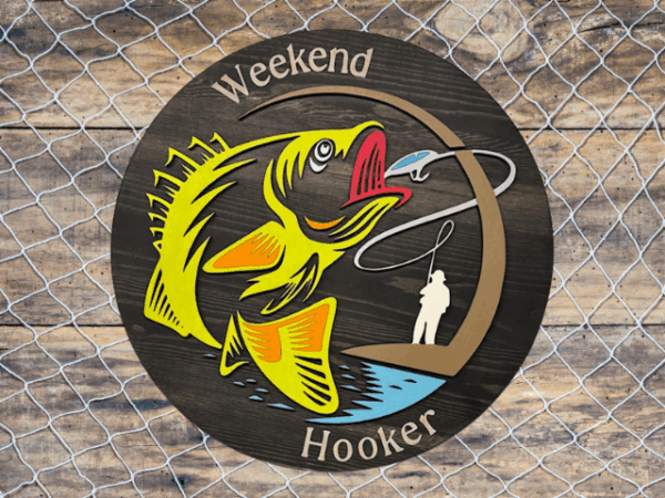 a rustic pine wood sign with a black stain finish, featuring laser-cut "Weekend Hooker" text, a vibrant lime green fish, and a fisherman silhouette, blending bold humor and fishing charm