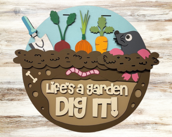 3D laser cut wood garden welcome sign showing a small furry animal coming out of the dirt with vegetables beside it and the words "Life's a Garden Dig It"